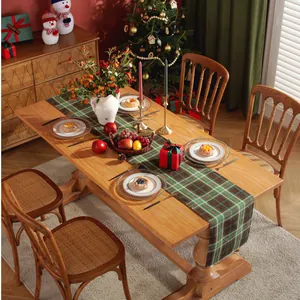 Classic Christmas plaid table runner in green and brown on a festive wooden dining table