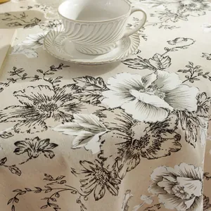 Linen floral tablecloth with vintage tassels and elegant retro beige flower patterns