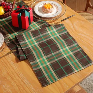 Detail of Christmas plaid table runner with green and brown Scottish checkered pattern