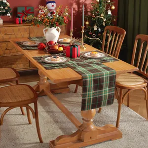 Christmas plaid table runner and placemat set in green and brown on a festive wooden table