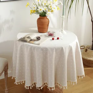 Round beige linen tablecloth with daisy floral prints and elegant tassel trim edge