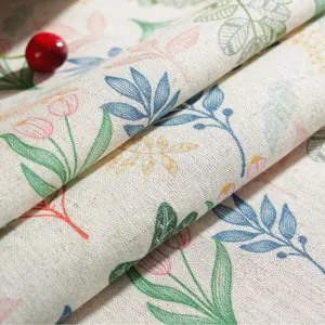 Close-up of linen fabric showing colorful leaf prints and fine woven texture