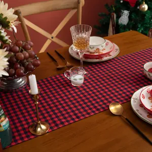 Close-up of red and black buffalo plaid table runner on a festive wooden dining table