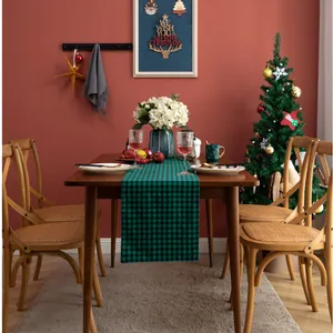 Close-up of green and black buffalo plaid table runner for Christmas dining decor
