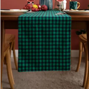 Close-up of green and black plaid table runner with durable cotton linen texture and stitching
