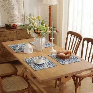 Set of 4 blue gradient cotton linen placemats with abstract stripes on a wooden dining table