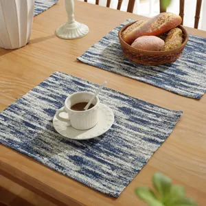 Blue gradient cotton linen placemats with abstract ink texture on wooden table