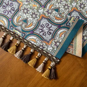 Détail d'un chemin de table jacquard bohème aux motifs variés et bords à franges