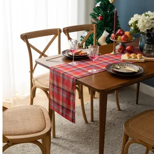 Detail of red and blue Scottish plaid table runner with festive holiday dinner settings
