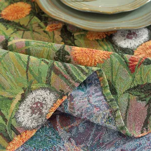 Detail of floral jacquard tablecloth fabric showing thick cotton linen weave and textures