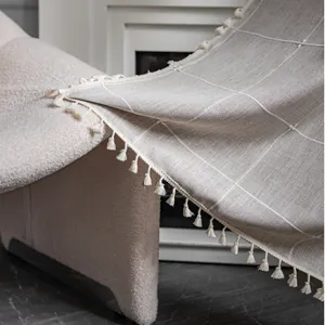 Close-up of beige plaid texture and tassel edge on minimalist cotton linen kitchen curtain