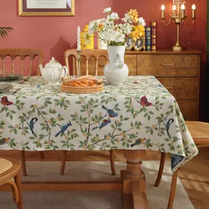 Detail of jacquard tablecloth featuring vintage floral bird patterns and thick texture