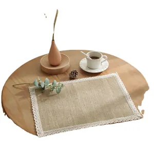 Rectangle jute placemat with white lace trim on wooden table with rustic coffee set