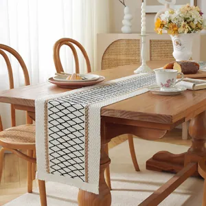 Detailed texture of cotton linen table runner with geometric patterns and tassels