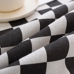 Detailed close-up of black and white checkerboard linen tablecloth texture and fabric