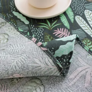 Close-up of tropical leaf linen tablecloth showing premium stitching and fabric texture