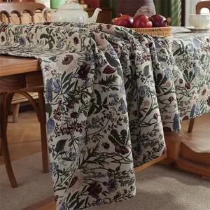 Close-up of floral jacquard fabric with wildflower and dragonfly patterns on tablecloth