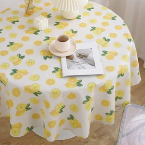 Linen cotton round tablecloth with yellow lemon pattern in a cozy home setting