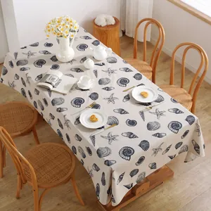 Detail of linen tablecloth with navy blue starfish and seashell ocean patterns