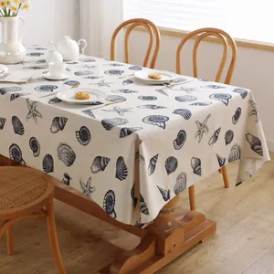 Rectangular linen tablecloth featuring blue sea shells and starfish on wooden table