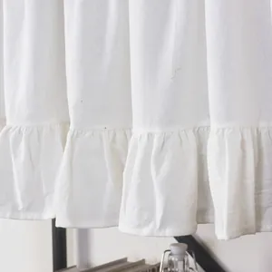 Macro detail of French style white ruffle short curtain with textured fabric weave