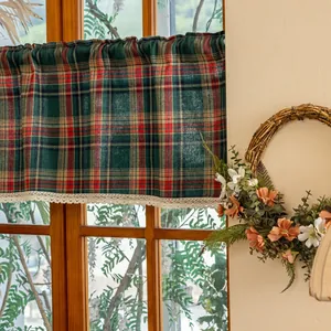 Detail of red and green plaid coffee curtain with elegant beige lace trim edging
