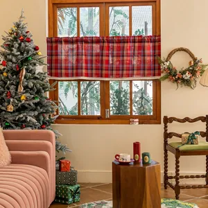 Detail of red and blue plaid cafe curtain with white lace trim on a wooden window
