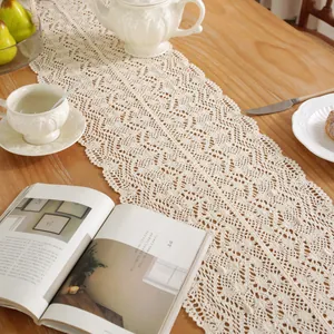 Beige hollow crochet table runner with delicate floral patterns for rustic home decor