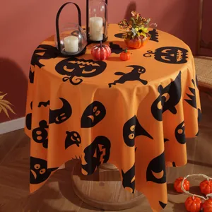 Orange round Halloween tablecloth featuring black pumpkin faces and ghost patterns