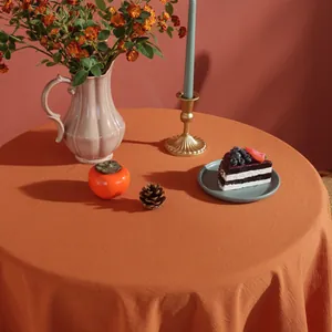 Orange linen round tablecloth with natural drape for modern home or cafe dining decor