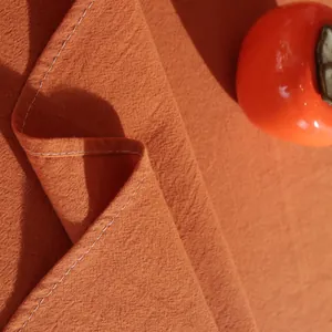 Burnt orange cotton linen tablecloth with white stitching detail and natural texture