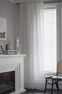 Detail of white Nordic lace curtain featuring intricate hollow four-leaf clover patterns