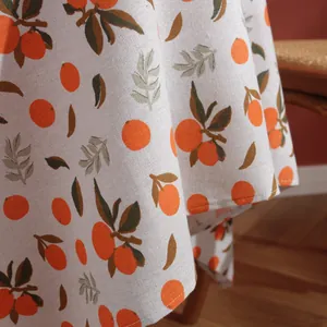 Nordic orange citrus print linen tablecloth with rustic texture and natural drape style