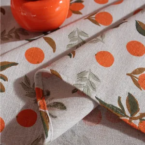 Nordic autumn orange print linen tablecloth with rustic texture and stitched edges