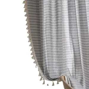 Linen stripe curtain with pom-pom fringe details in a minimalist gray and white design
