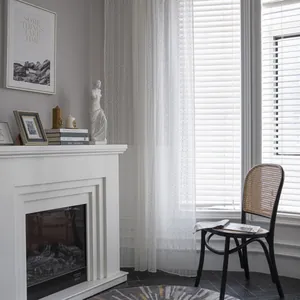 White Nordic lace curtains with floral patterns in a minimalist modern living room