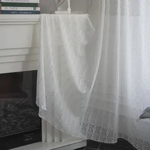 White Nordic lace curtain with hollow four-leaf clover patterns in elegant home setting