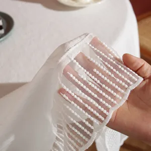 Elegant white lace tablecloth with circular embroidery and semi-transparent texture