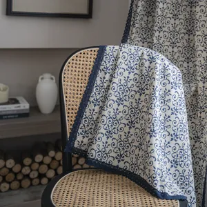 Close-up of vintage blue floral linen fabric with exquisite lace border on a chair