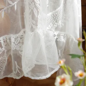 White lace wedding tablecloth with vintage crochet patterns and tiered ruffle edges