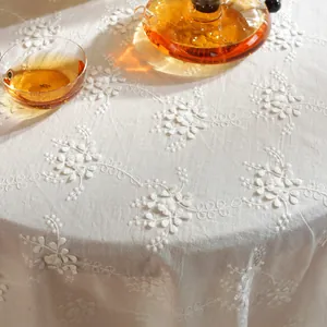 White floral embroidered tablecloth with wavy edges and premium linen texture for tea tables