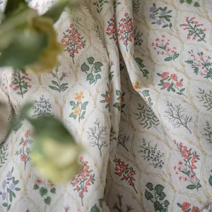 Detail of floral patterns and diamond lattice texture on beige cotton-linen fabric