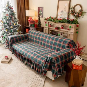 Detail of red and green plaid sofa cover with elegant ruffled edges for Christmas decor