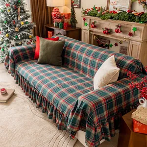 Close-up of Christmas plaid sofa cover with ruffle skirt in festive home setting