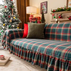 Close-up of vintage red and green plaid sofa cover with ruffle trim for festive decor