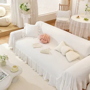 White sofa cover featuring elegant ruffled edges and premium textured cotton fabric