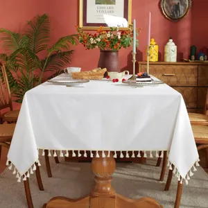 Elegant white rectangular tablecloth with decorative fringe tassels for home dining decor