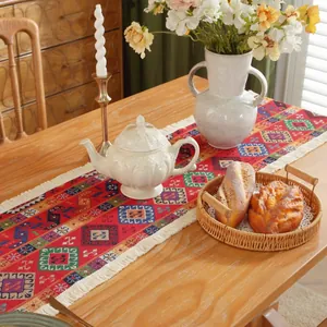 Vista dettagliata del runner da tavola jacquard con motivi floreali retrò e frange
