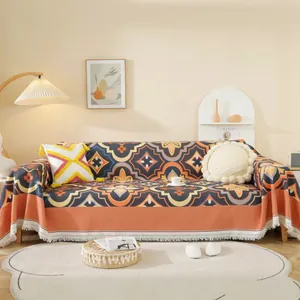 Manta para sofá de estilo nórdico con diseño geométrico naranja y azul y borlas