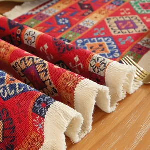 Dettaglio del runner da tavola jacquard bohémien con motivi geometrici e nappe bianche